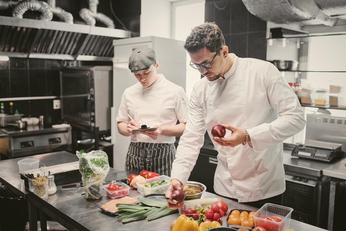 Chefs preparing vegetables in a commercial kitchen